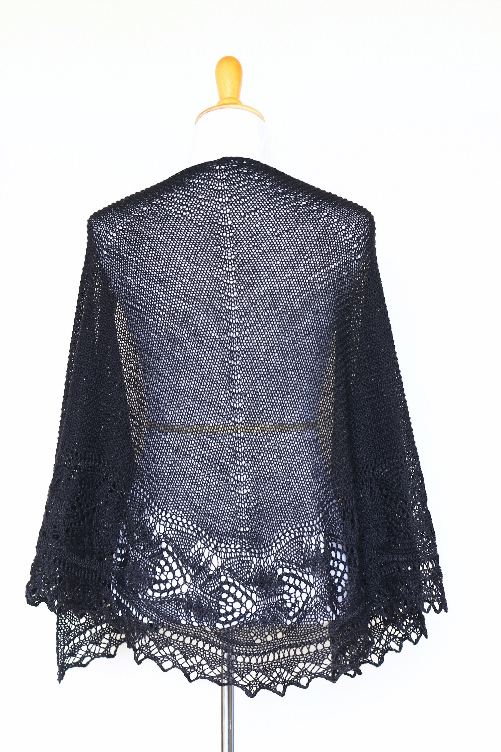 Knit shawl with laced border in black color