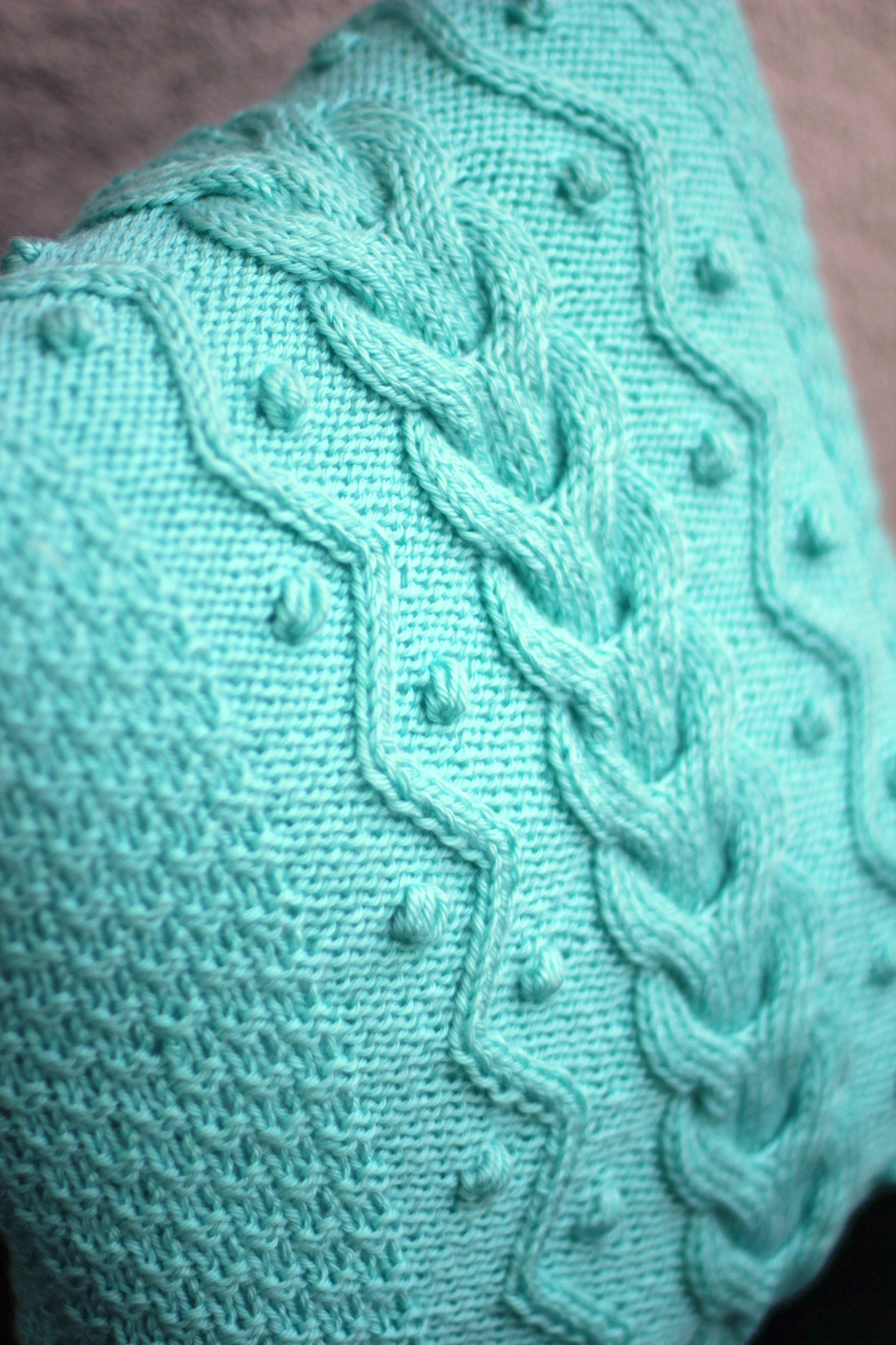 Knit cabled pillow cover with nupps for home decor