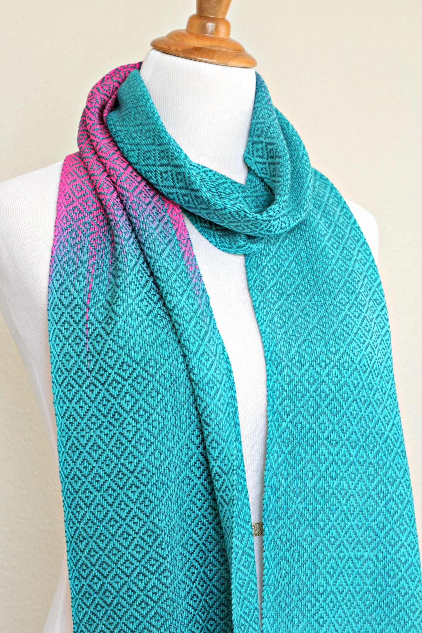 Woven scarf in blue and neon pink with woven pattern and twisted fringe
