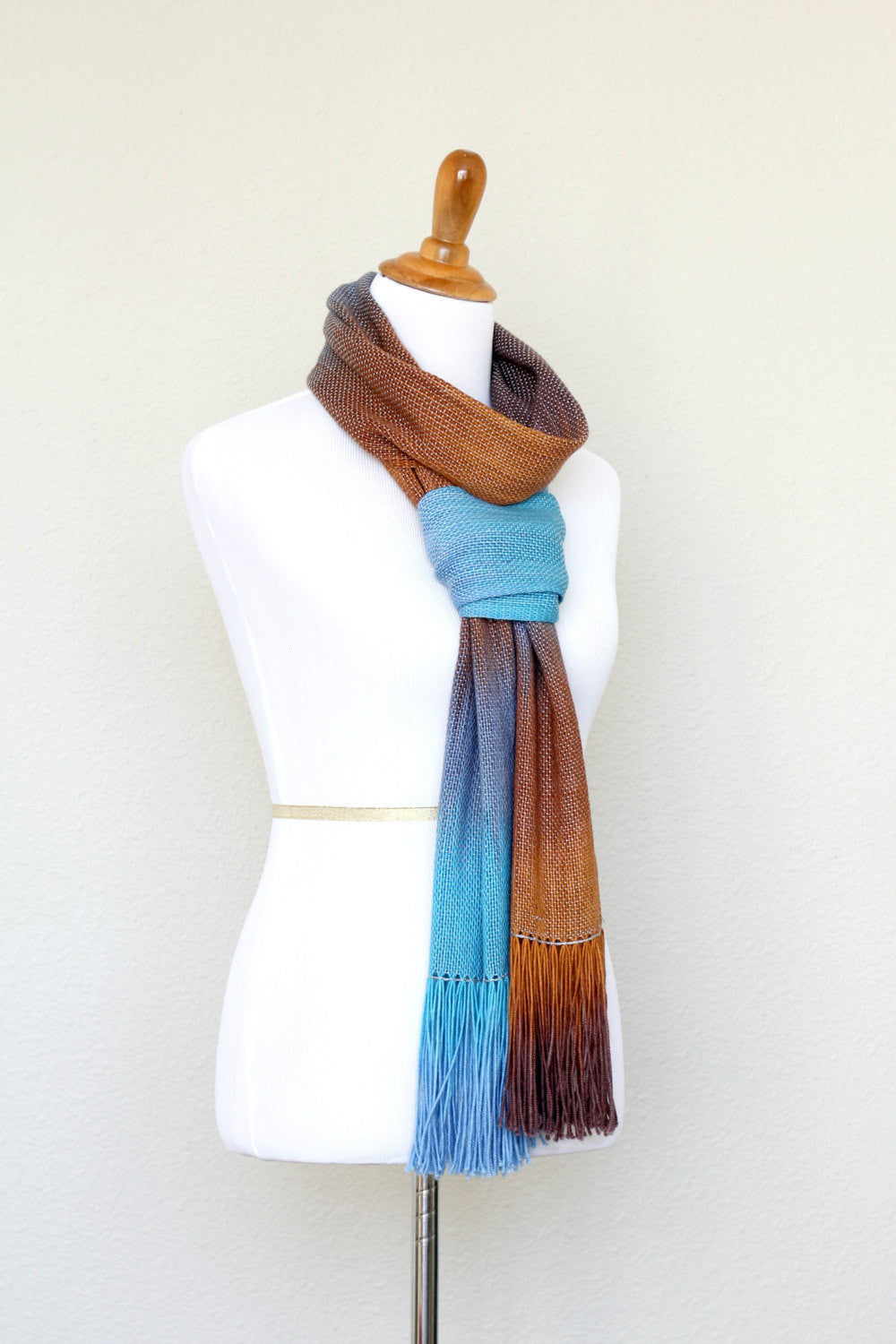 Woven scarf in turquoise, blue and brown colors