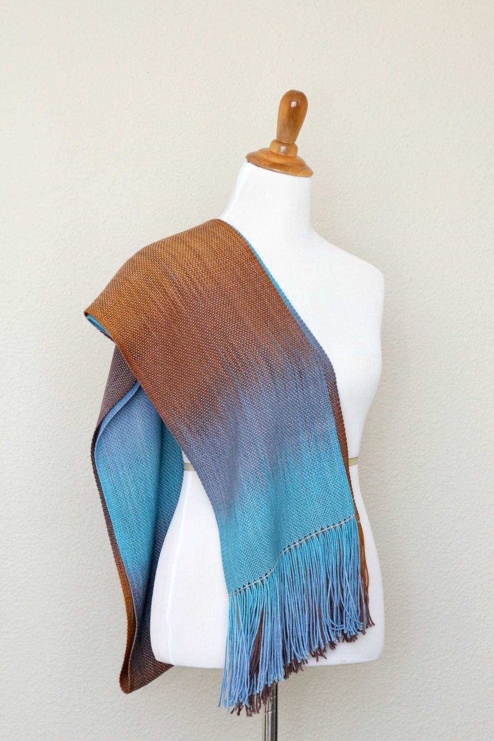 Woven scarf in turquoise, blue and brown colors