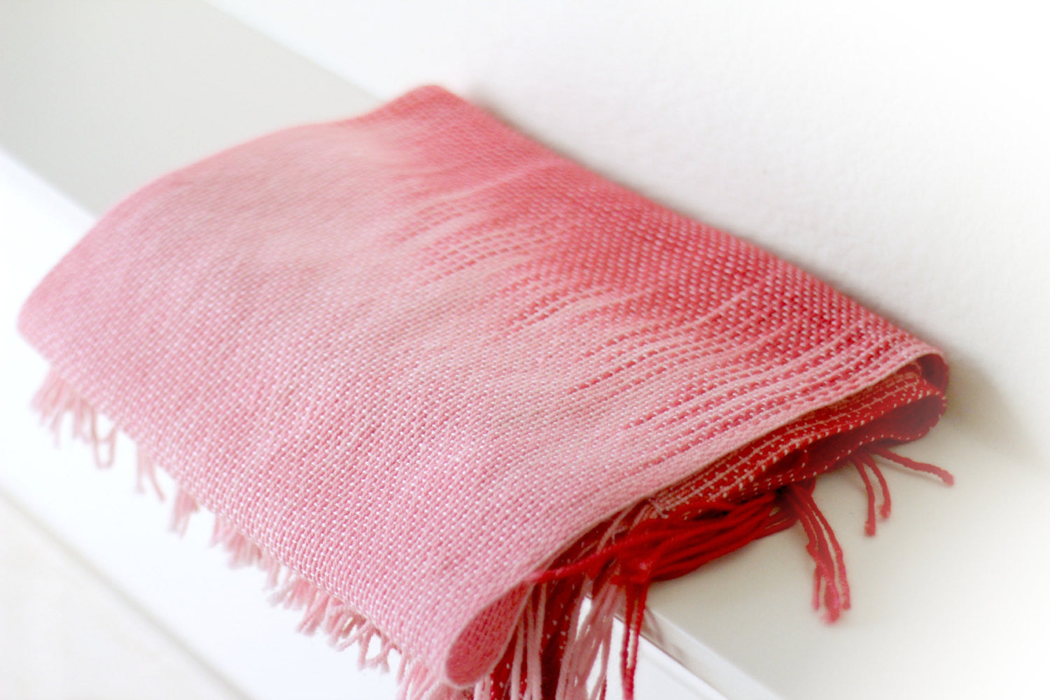 Hand woven scarf in red and pink shades