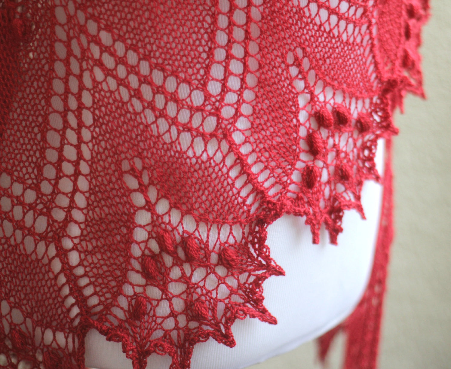 Knitted red shawl with nupps
