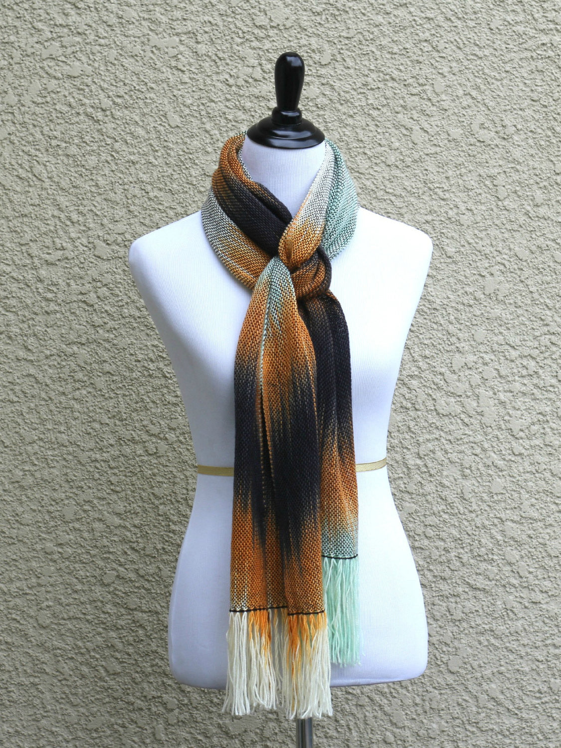 Hand woven scarf in white, orange, black and mint colors