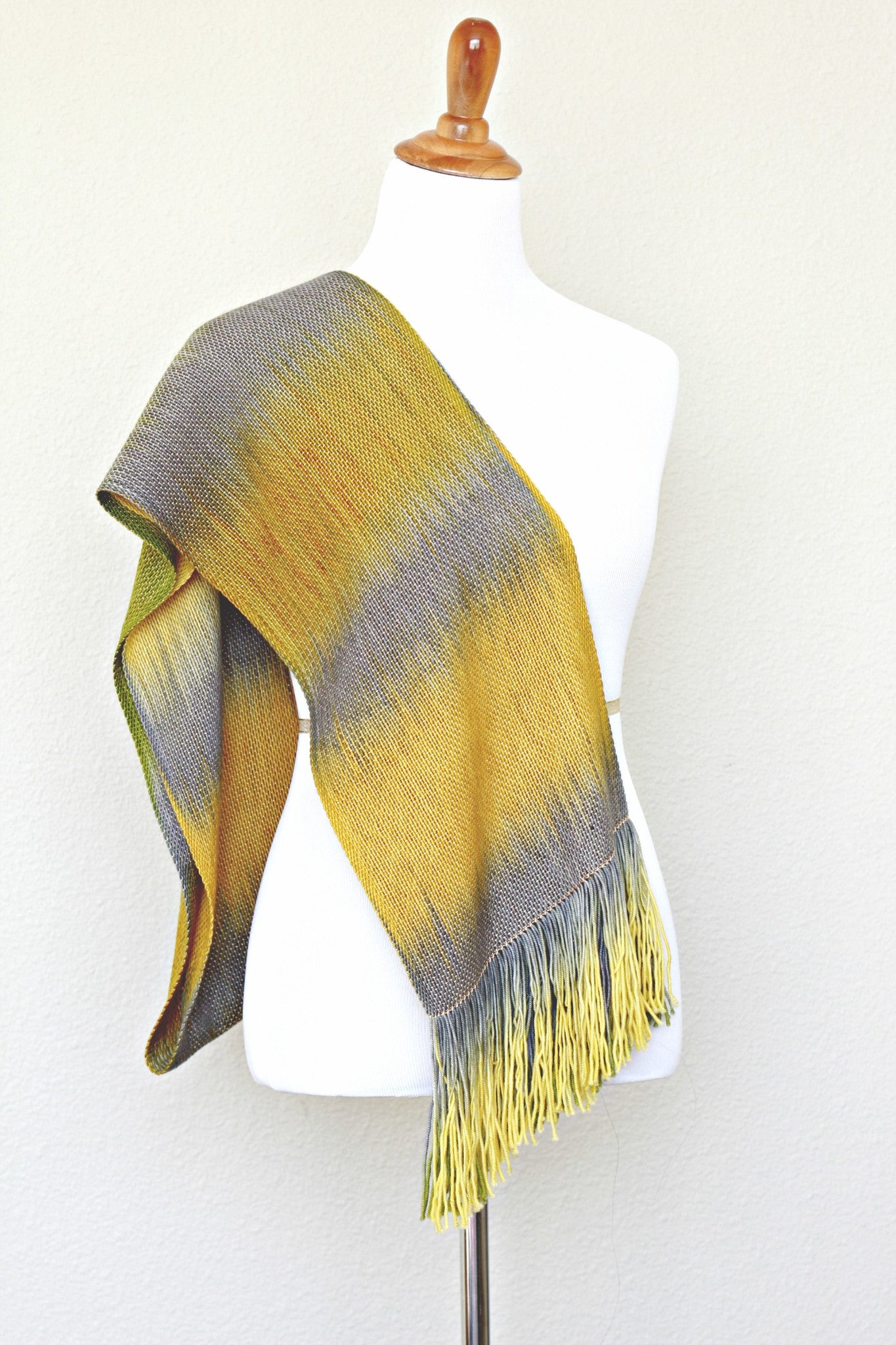 Woven scarf in mustard, green and grey colors