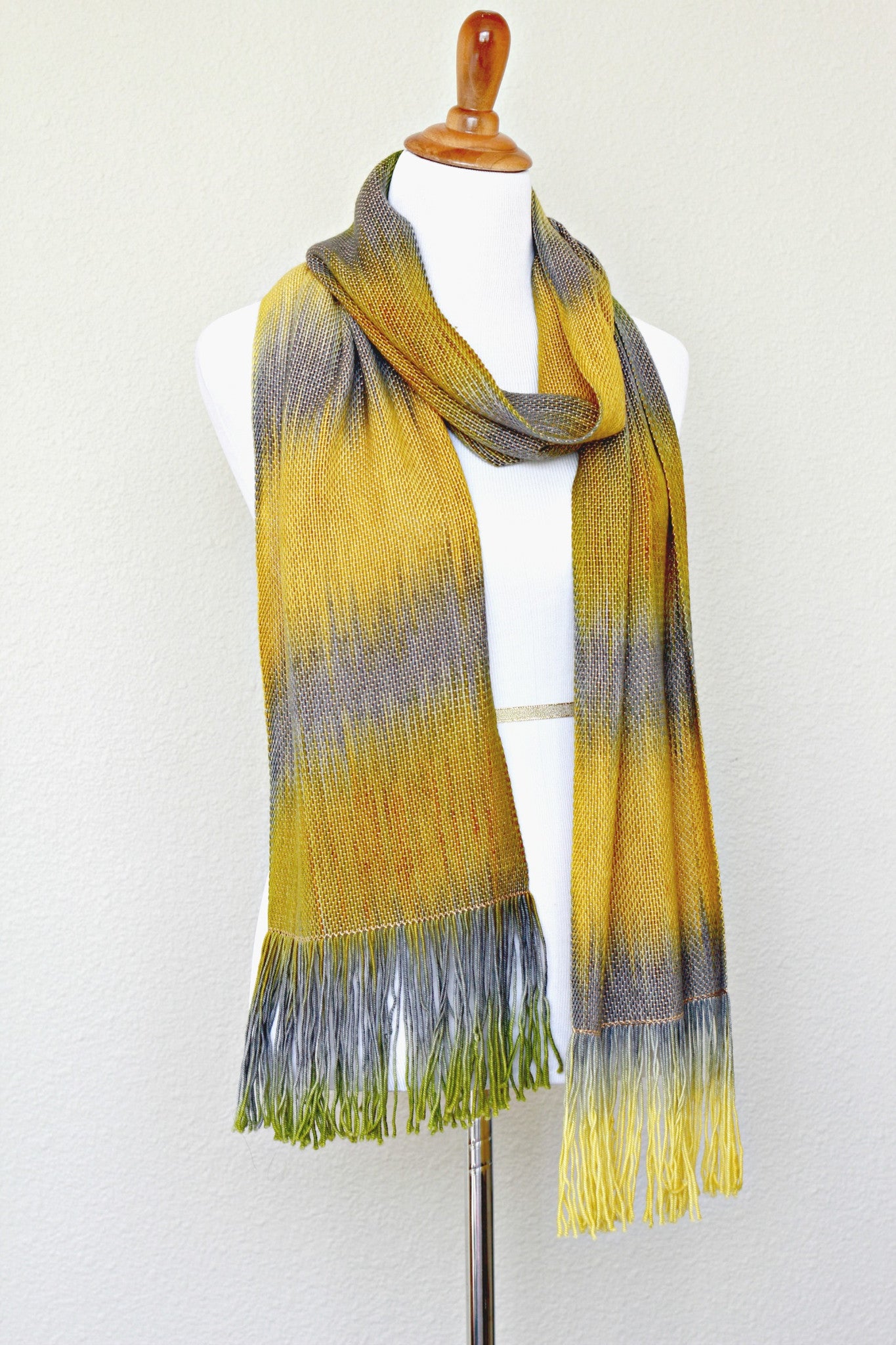 Woven scarf in mustard, green and grey colors