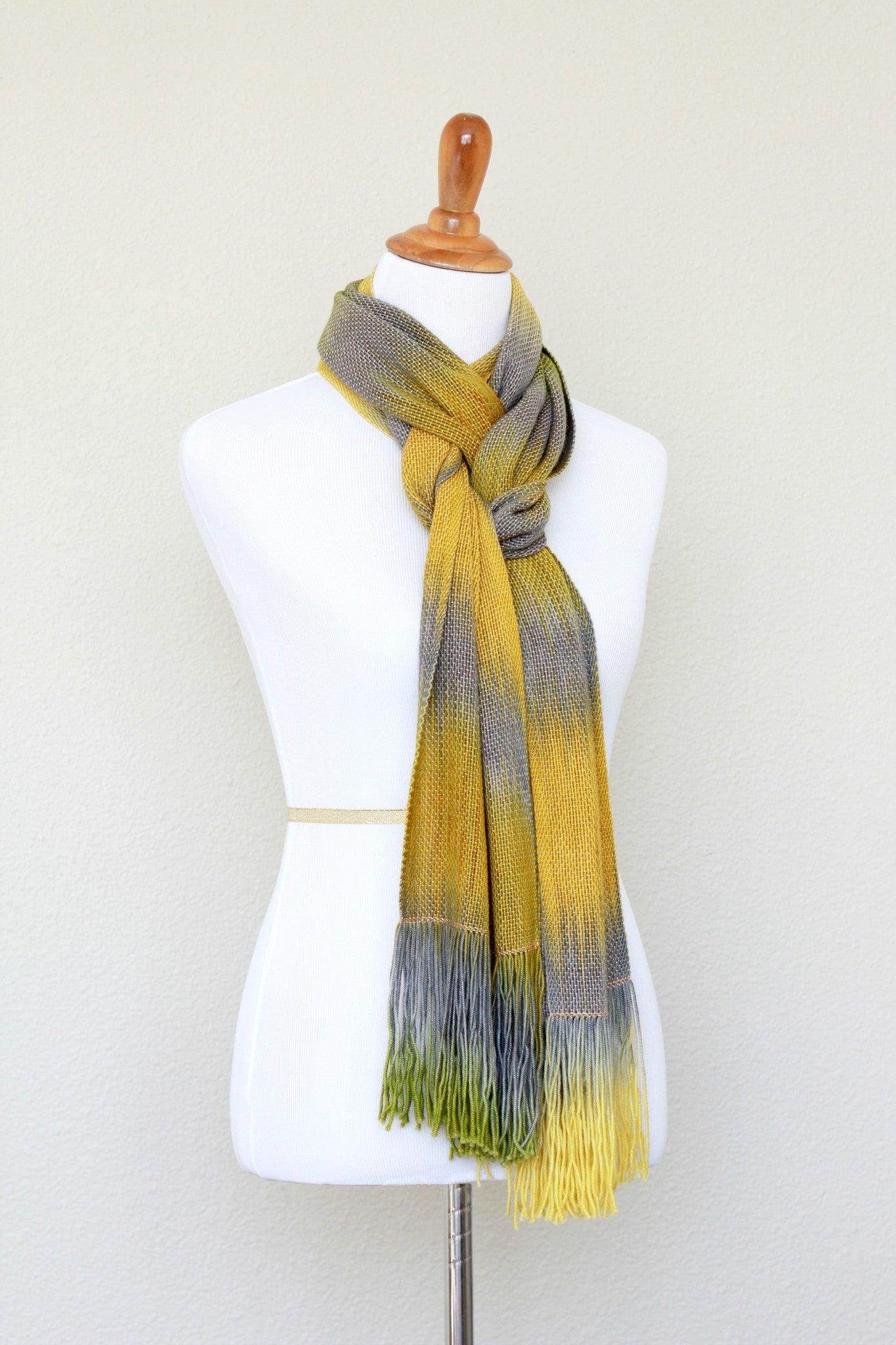 Woven scarf in mustard, green and grey colors