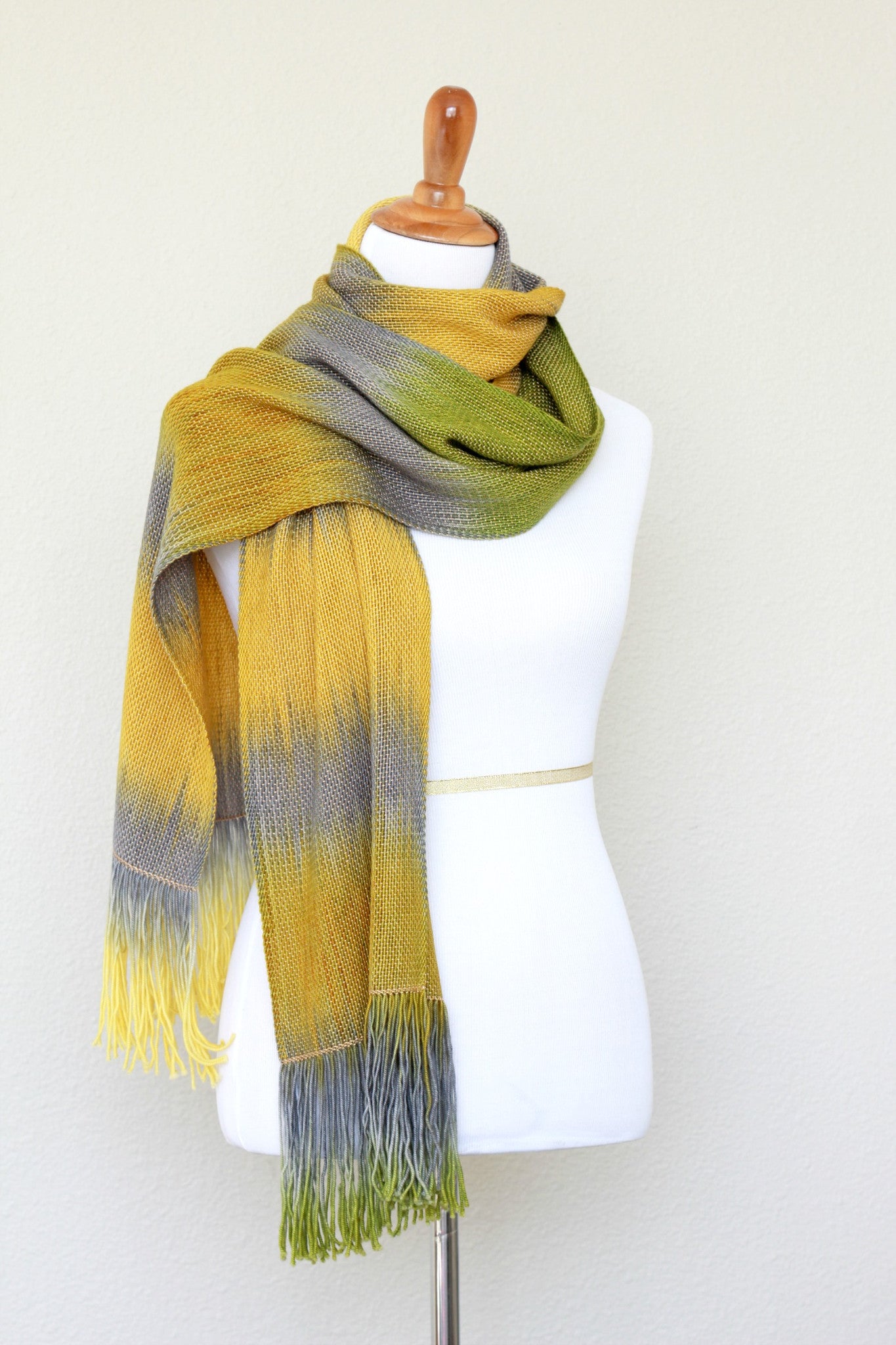 Woven scarf in mustard, green and grey colors