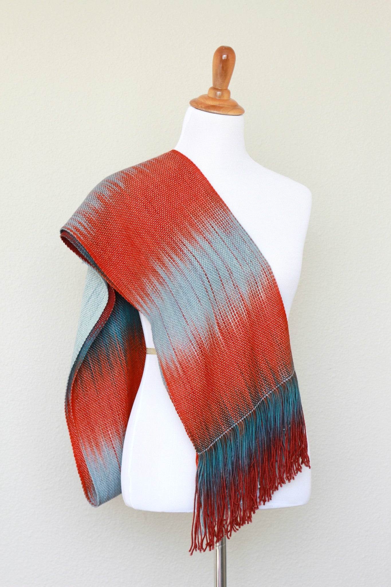 Woven scarf in blue grey, red and teal colors