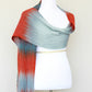 Woven scarf in blue grey, red and teal colors
