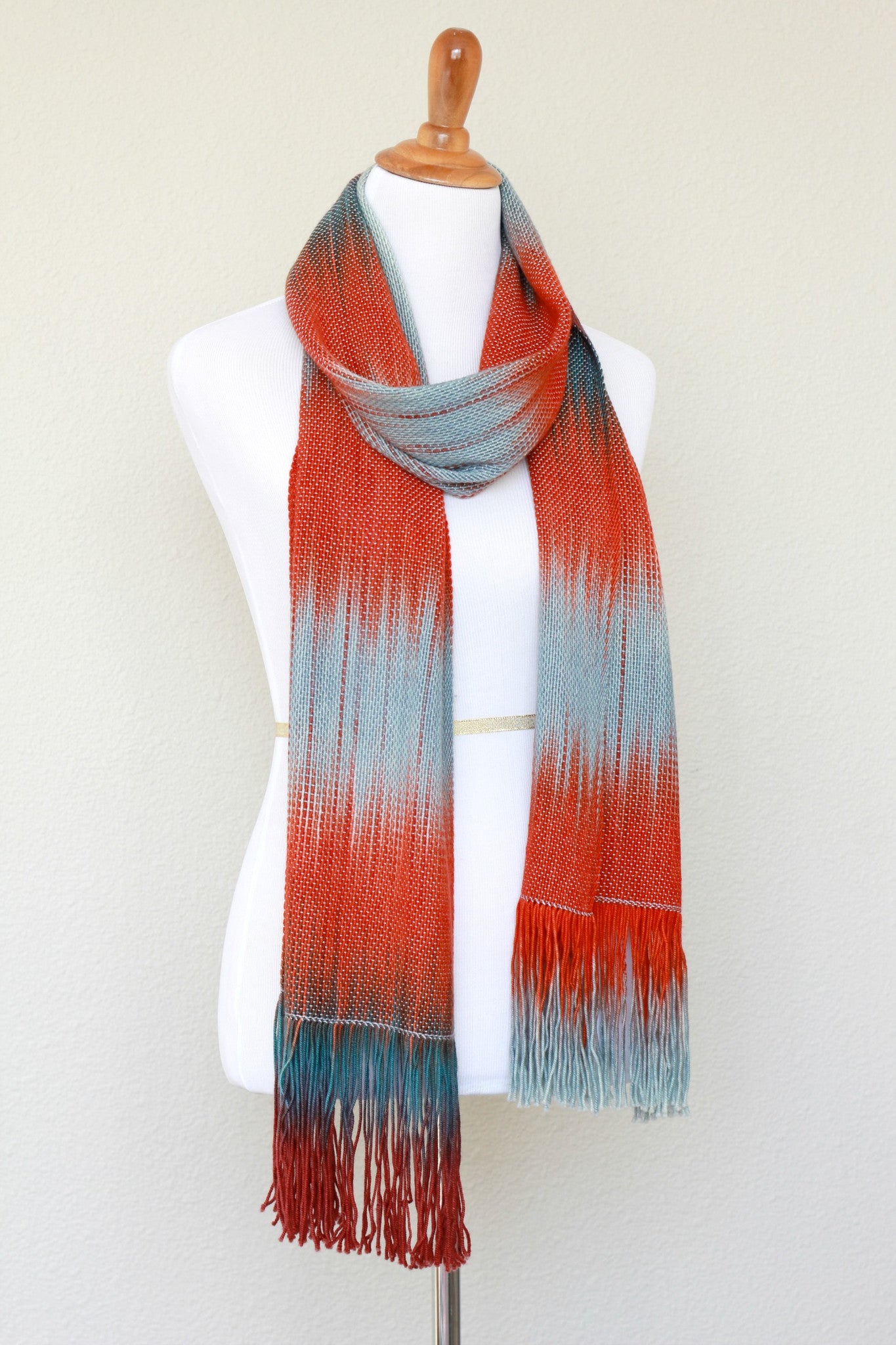 Woven scarf in blue grey, red and teal colors