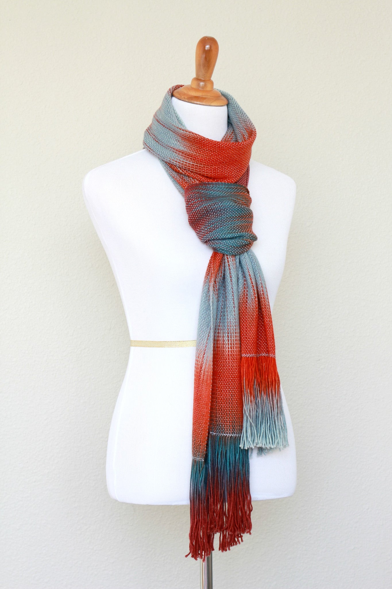 Woven scarf in blue grey, red and teal colors