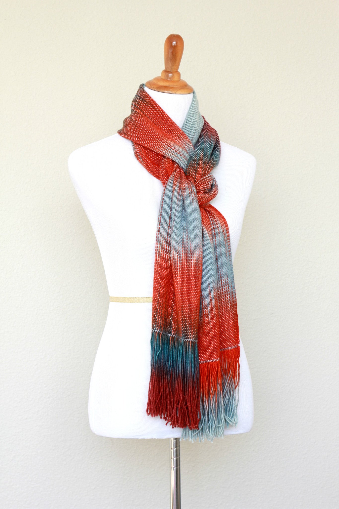 Woven scarf in blue grey, red and teal colors