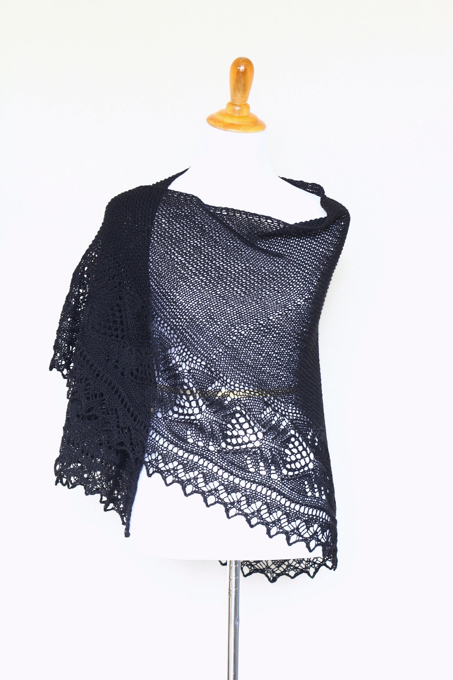 Knit shawl with laced border in black color