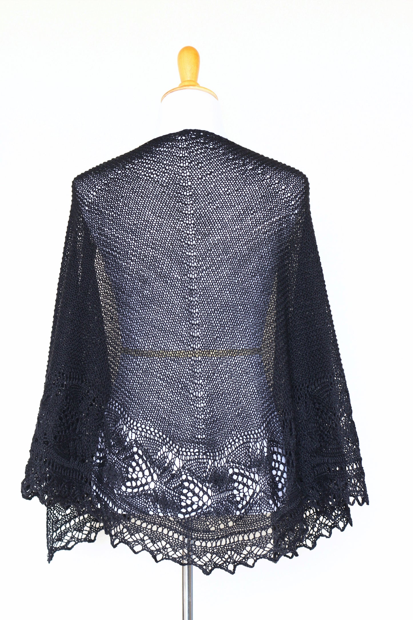 Knit shawl with laced border in black color