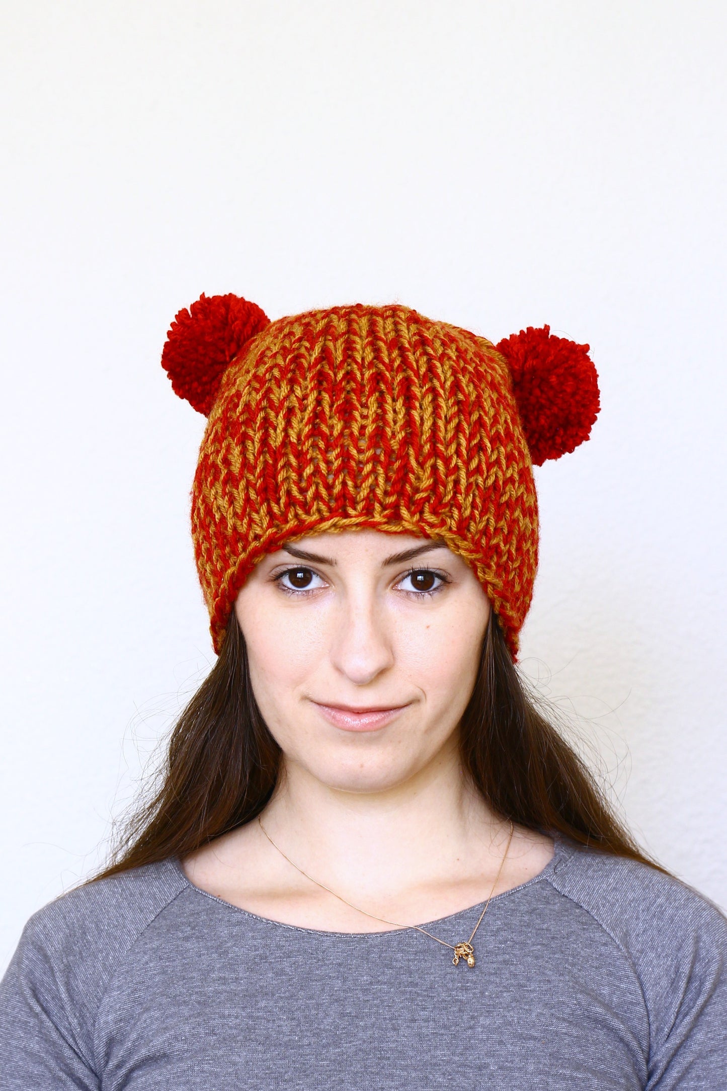 Knit hat with two poms, knit skull hat in red orange color