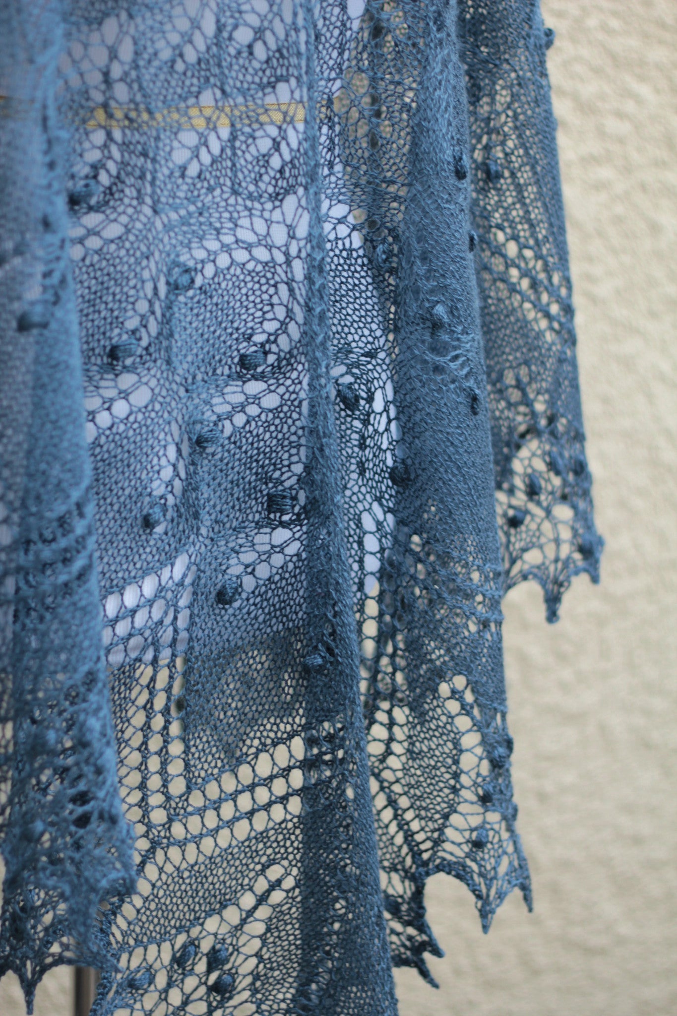 Knit lace shawl in grey blue color with nupps