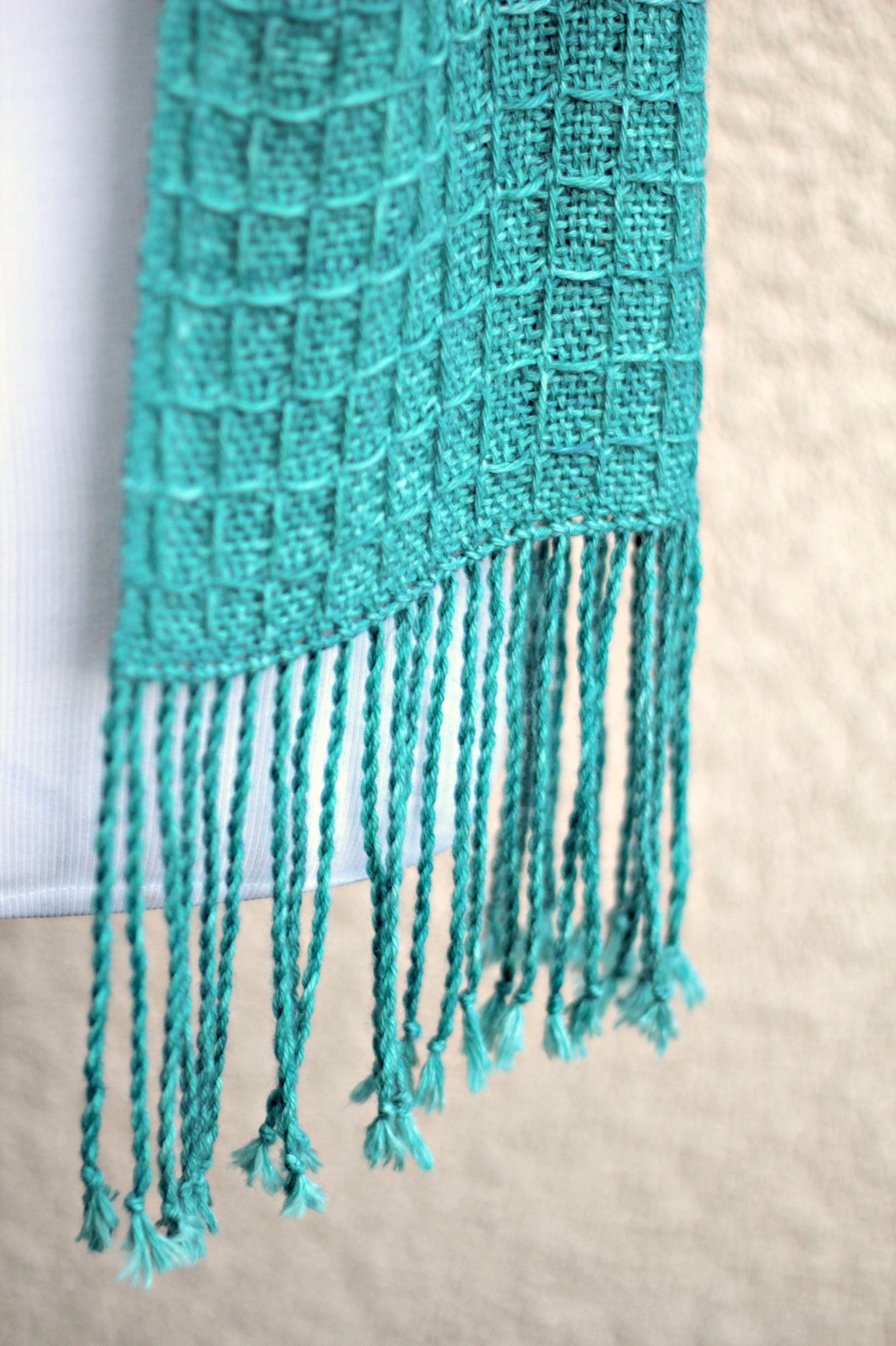 Hand woven scarf in turquoise teal colors in waffle pattern