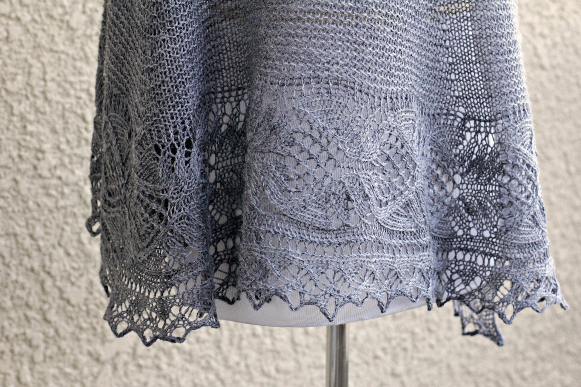 Knit shawl with laced border in grey color