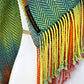 Woven scarf in blue, orange, purple and yellow colors with twill pattern and twisted fringe