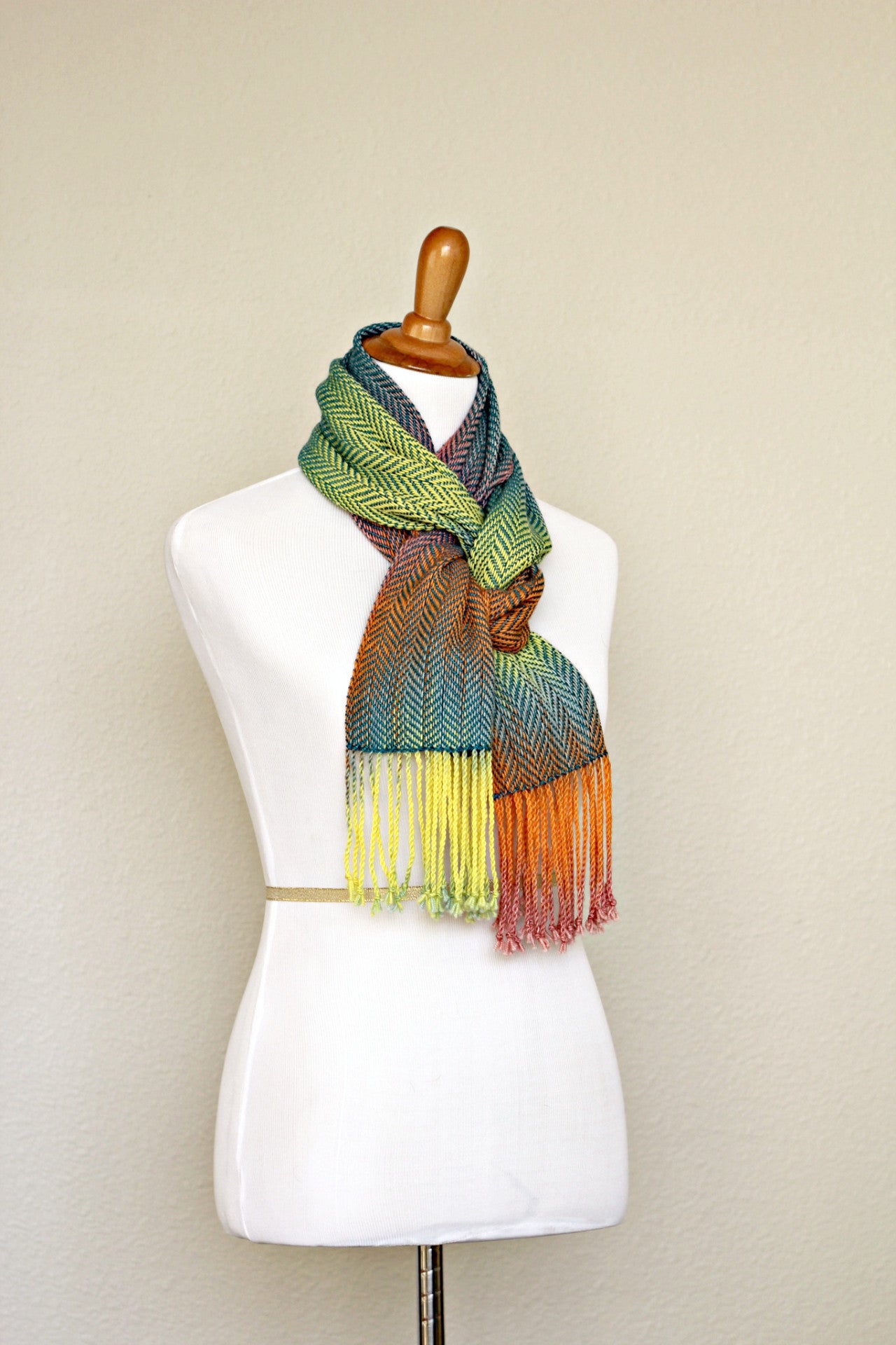 Woven scarf in blue, orange, purple and yellow colors with twill pattern and twisted fringe