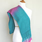 Woven scarf in blue and neon pink with woven pattern and twisted fringe