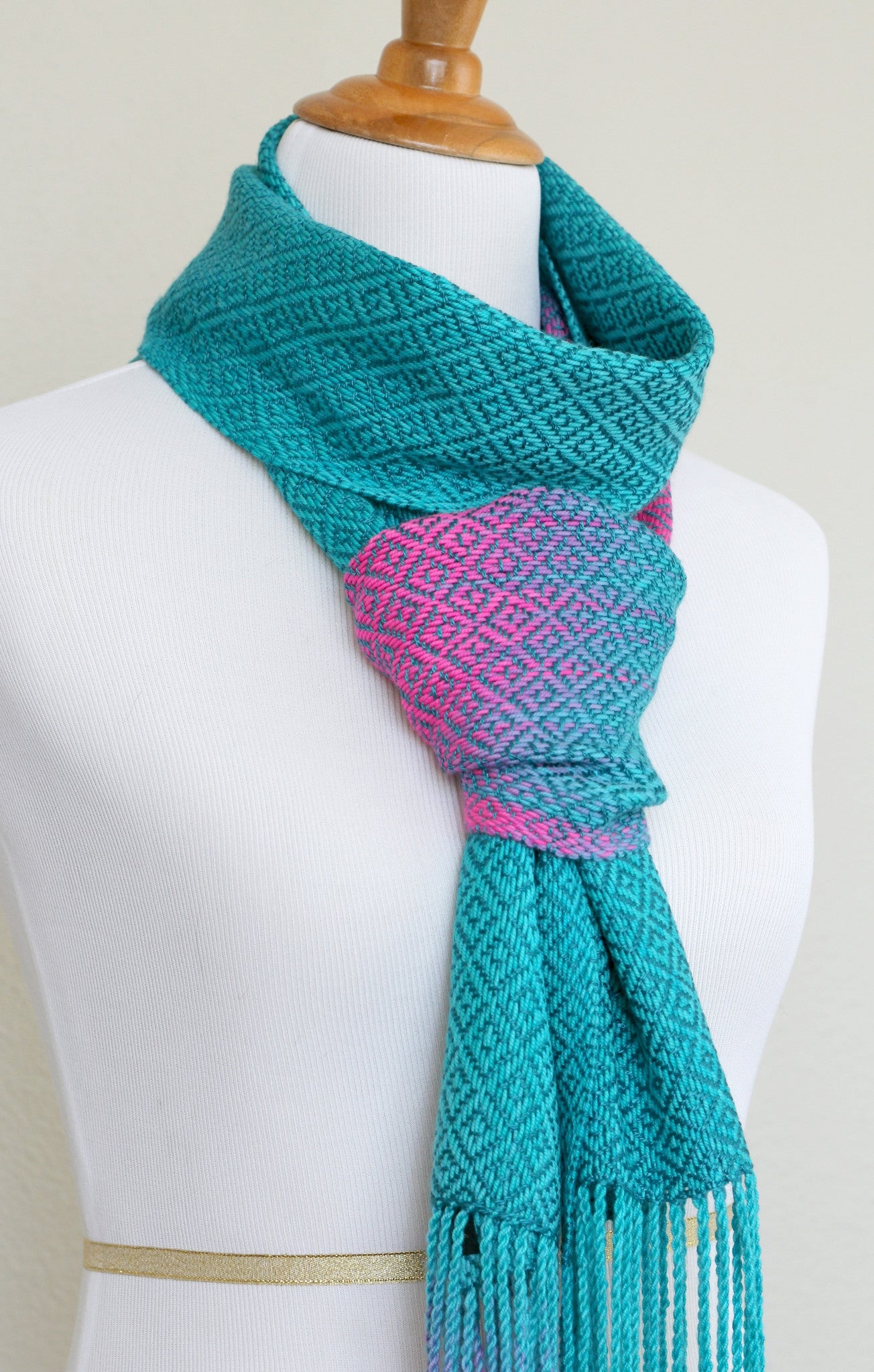 Woven scarf in blue and neon pink with woven pattern and twisted fringe