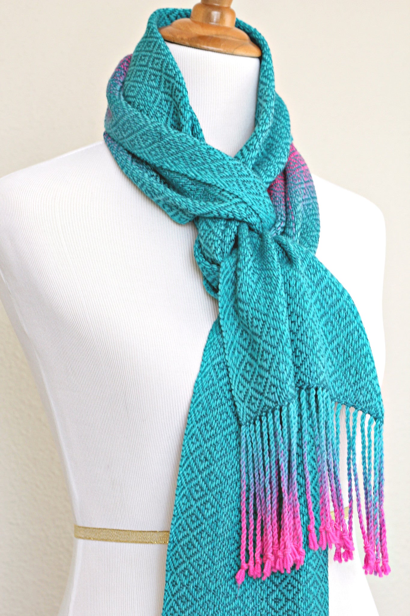 Woven scarf in blue and neon pink with woven pattern and twisted fringe