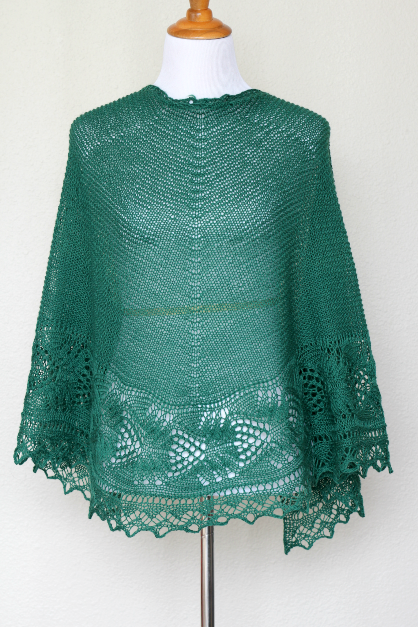 Knit shawl with laced border in forest green color