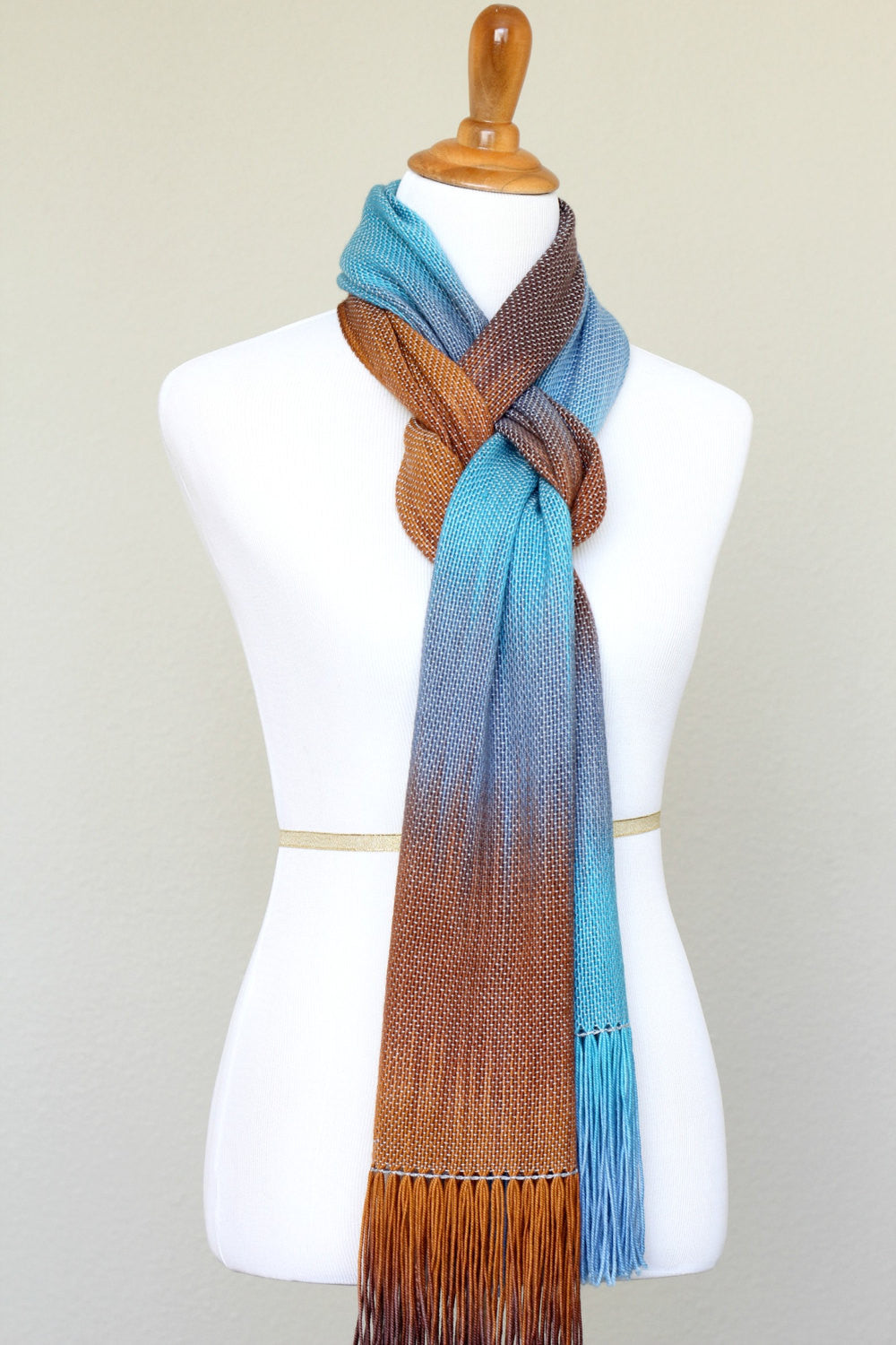 Woven scarf in turquoise, blue and brown colors