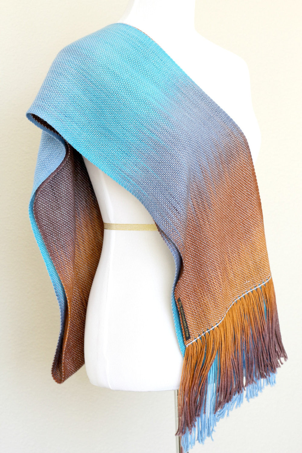 Woven scarf in turquoise, blue and brown colors