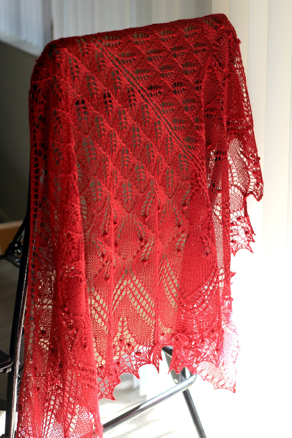 Red knitted lace shawl