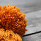 Knit honeycomb hat for women with cables and pompom in orange color