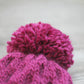 Pink knit hat with pompom