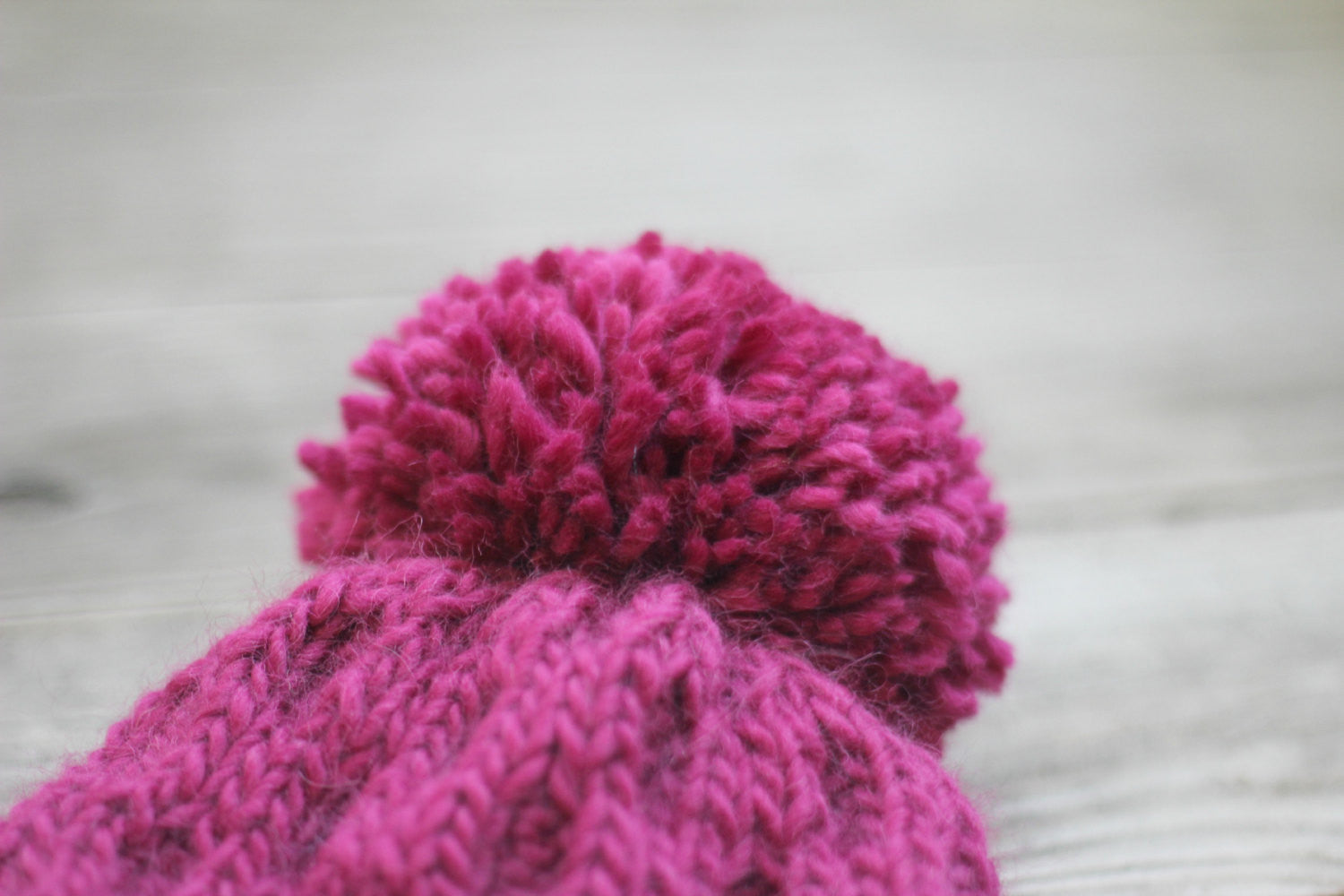 Pink knit hat with pompom